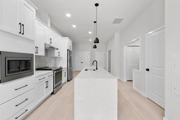 Clinton apartment for rent - A modern kitchen with white cabinets and appliances.