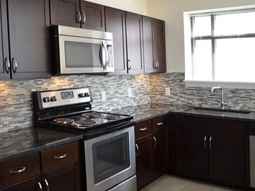 Bridgeport apartment for rent - A kitchen with a stove top oven and microwave above it.