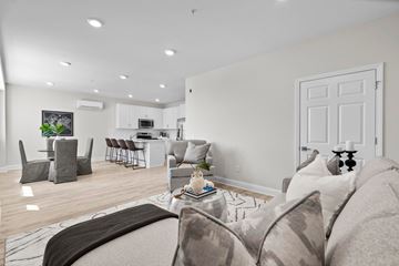 New London apartment for rent - A living room with a grey couch and a coffee table.