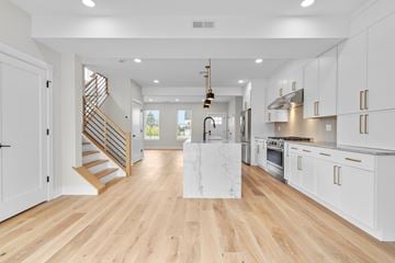 North Haven apartment for rent - A modern kitchen with white cabinets and a wooden floor.