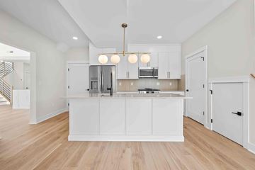 North Haven apartment for rent - A kitchen with white cabinets and a wooden floor.