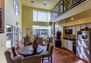 Little Rock apartment for rent - A kitchen with a table and chairs in the middle of the room.