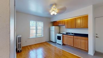 Chicago apartment for rent - A kitchen with wooden cabinets and a white refrigerator.
