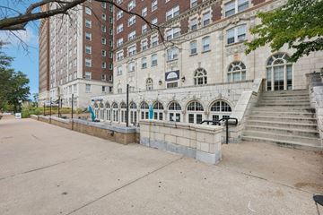 St. Louis apartment for rent - A large building with a balcony and stairs in front.