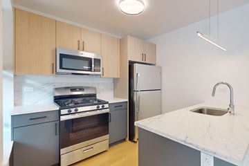 Chicago apartment for rent - A kitchen with a stove, oven, refrigerator, and microwave.
