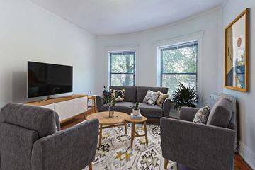 Chicago apartment for rent - A living room with grey couches and a television.