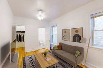 Chicago apartment for rent - A living room with a grey couch and a wooden coffee table.