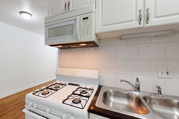Chicago apartment for rent - A white stove and sink in a kitchen.