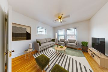 Chicago apartment for rent - A living room with a striped rug and a grey couch.