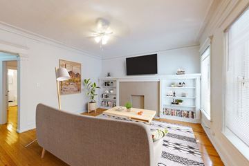 Chicago apartment for rent - A living room with a grey couch and a fireplace.
