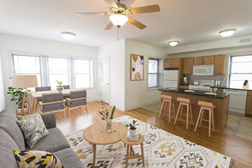 Chicago apartment for rent - A living room with a grey couch and a wooden coffee table.