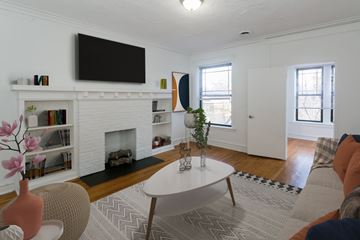 Chicago apartment for rent - A living room with a fireplace and a television mounted above it.