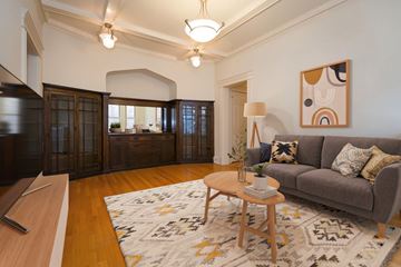Chicago apartment for rent - A living room with a grey couch and a patterned rug.