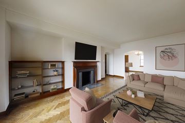 Chicago apartment for rent - A living room with a fireplace and a television on the wall.