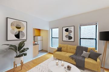 Chicago apartment for rent - A living room with a yellow couch and a large abstract painting on the wall.