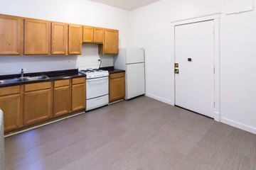Chicago apartment for rent - A kitchen with wooden cabinets and a white fridge.
