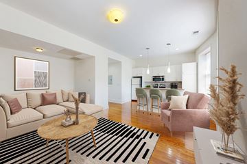Chicago apartment for rent - A living room with a black and white striped rug and a wooden coffee table.
