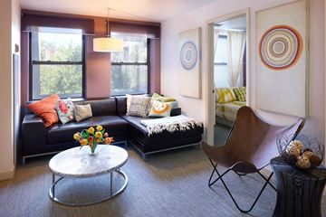 Chicago apartment for rent - A living room with a black couch and a white coffee table.
