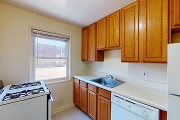 River Edge apartment for rent - A kitchen with wooden cabinets and white appliances.