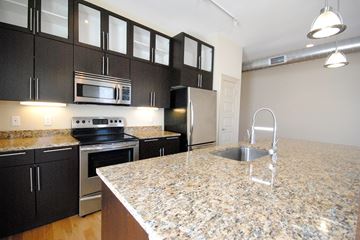 St. Louis apartment for rent - A kitchen with granite countertops and stainless steel appliances.