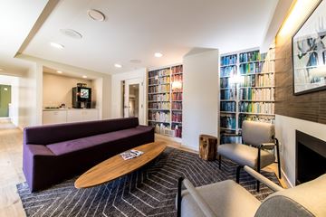 St. Louis apartment for rent - A living room with a purple couch and a fireplace.