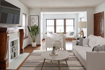 Kansas City apartment for rent - A living room with a white couch, a coffee table, and a fireplace.
