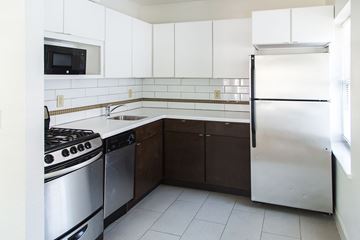Kansas City apartment for rent - A kitchen with white cabinets and a stainless steel refrigerator.