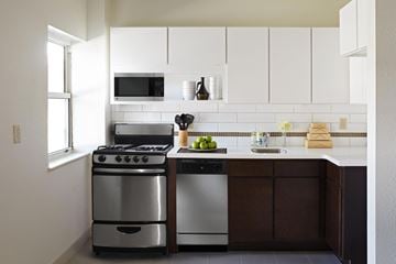 Kansas City apartment for rent - A modern kitchen with a stainless steel oven and microwave above the stove.