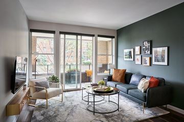 Kansas City apartment for rent - A living room with a black couch and a coffee table.