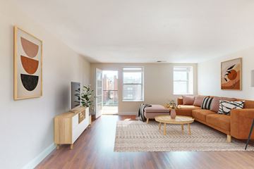 St. Louis apartment for rent - A living room with a brown couch and a wooden cabinet.