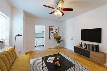 Kansas City apartment for rent - A living room with a yellow sofa and a black coffee table.