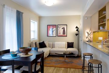 Kansas City apartment for rent - A living room with a couch, a table, and a painting on the wall.