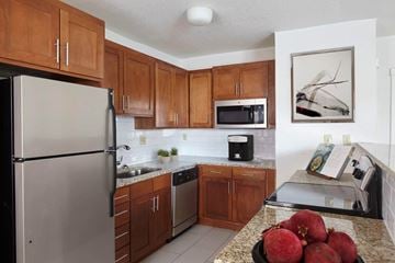 Kansas City apartment for rent - A kitchen with a refrigerator, microwave, and sink.