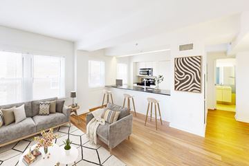 Kansas City apartment for rent - A modern living room with a grey sofa and a coffee table.
