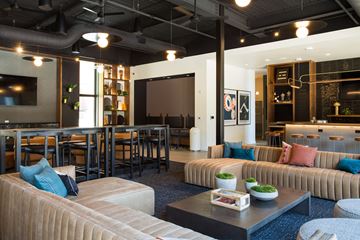 Kansas City apartment for rent - A modern living room with a large couch and a coffee table.