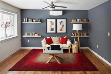 Kansas City apartment for rent - A living room with a red rug and a white couch.