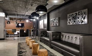 St. Louis apartment for rent - A modern living room with a dark grey sofa and wooden stumps on the floor.