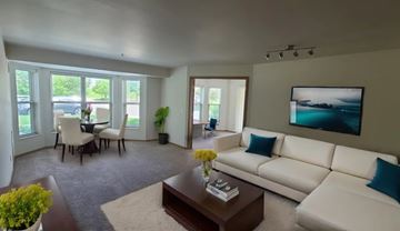 Oakdale apartment for rent - A living room with a white couch, a coffee table, and a painting on the wall.