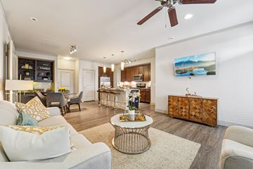 Kingwood apartment for rent - A living room with a white couch and a painting on the wall.