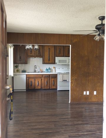 Fresno apartment for rent - A kitchen with wooden cabinets and a white dishwasher.