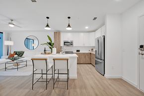 Tampa apartment for rent - A modern kitchen with a dining table and chairs.