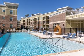 Clayton apartment for rent - A large swimming pool in front of apartment buildings.