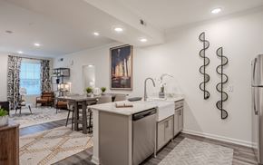Clayton apartment for rent - A modern kitchen with a large island and a dining area.