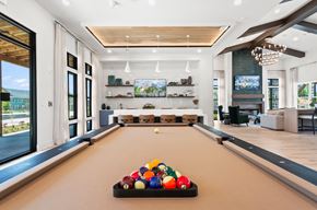 Lawrenceville apartment for rent - A pool table with a variety of balls on it in a room with a lot of windows.