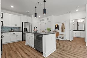 Lawrenceville apartment for rent - A modern kitchen with white cabinets and a wooden island.