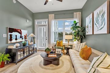 Alpharetta apartment for rent - A living room with a white sofa and a coffee table in the center.