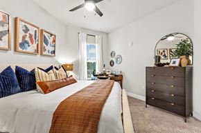 Alpharetta apartment for rent - A bedroom with a large bed and a dresser.