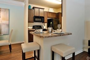 Port Wentworth apartment for rent - Designer kitchens with bar seating and black appliances at The Columns at Coldbrook Station, 31407