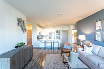 Spring Hill apartment for rent - a living room and kitchen with a couch and a table
