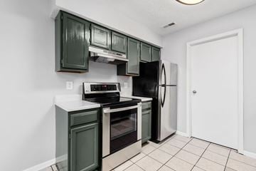 Columbus apartment for rent - A kitchen with green cabinets and black appliances.